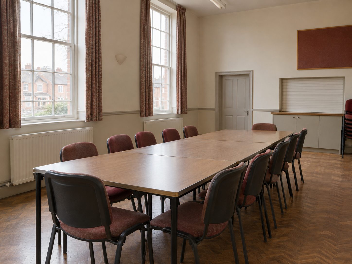 A plain meeting room set out for a residents' meeting