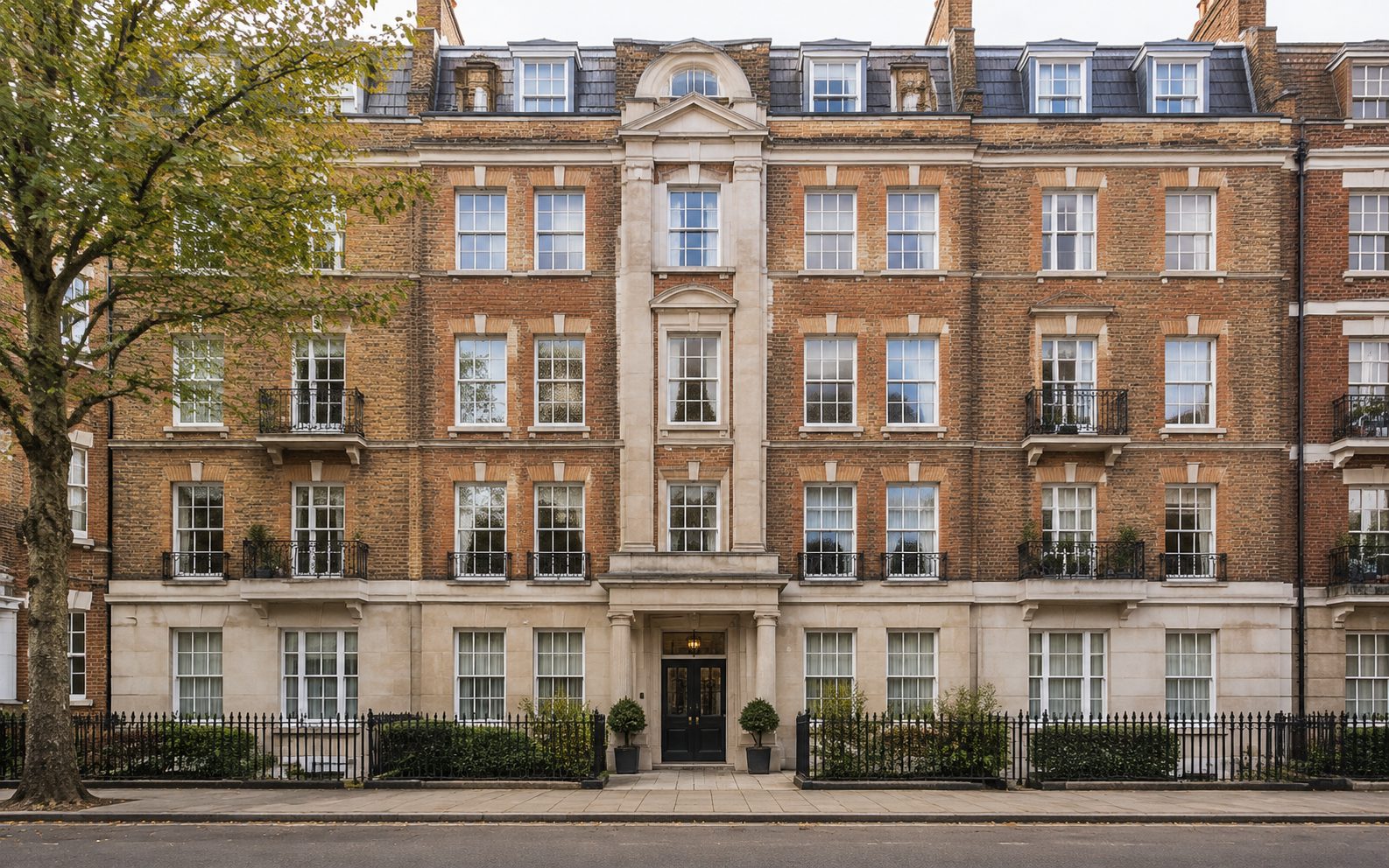 The facade of a mansion block above a shared entrance