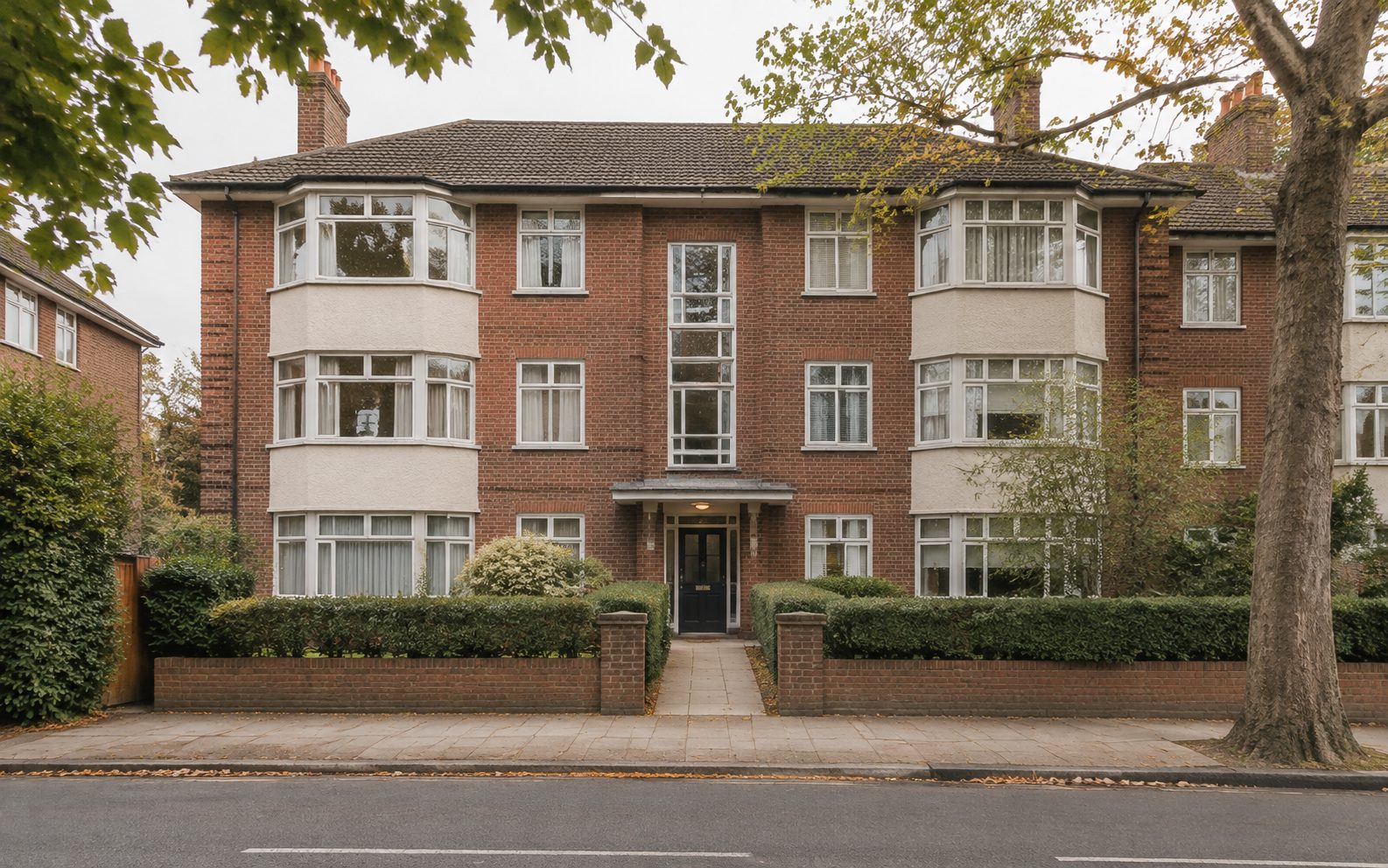 A low-rise residential apartment block on a leafy street