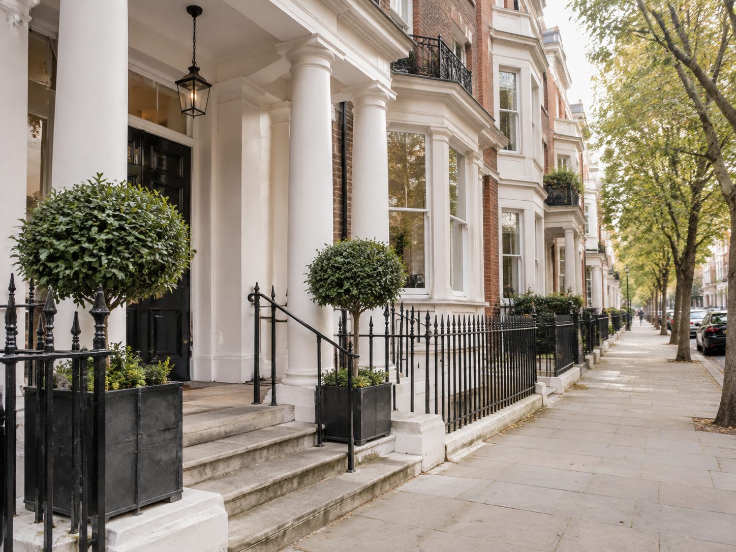 The entrance of a mansion block with railings