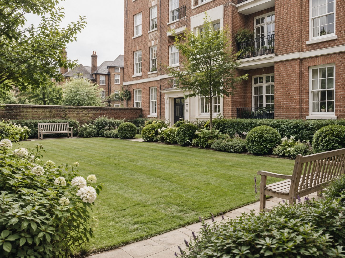 A communal residents' garden in front of a brick block