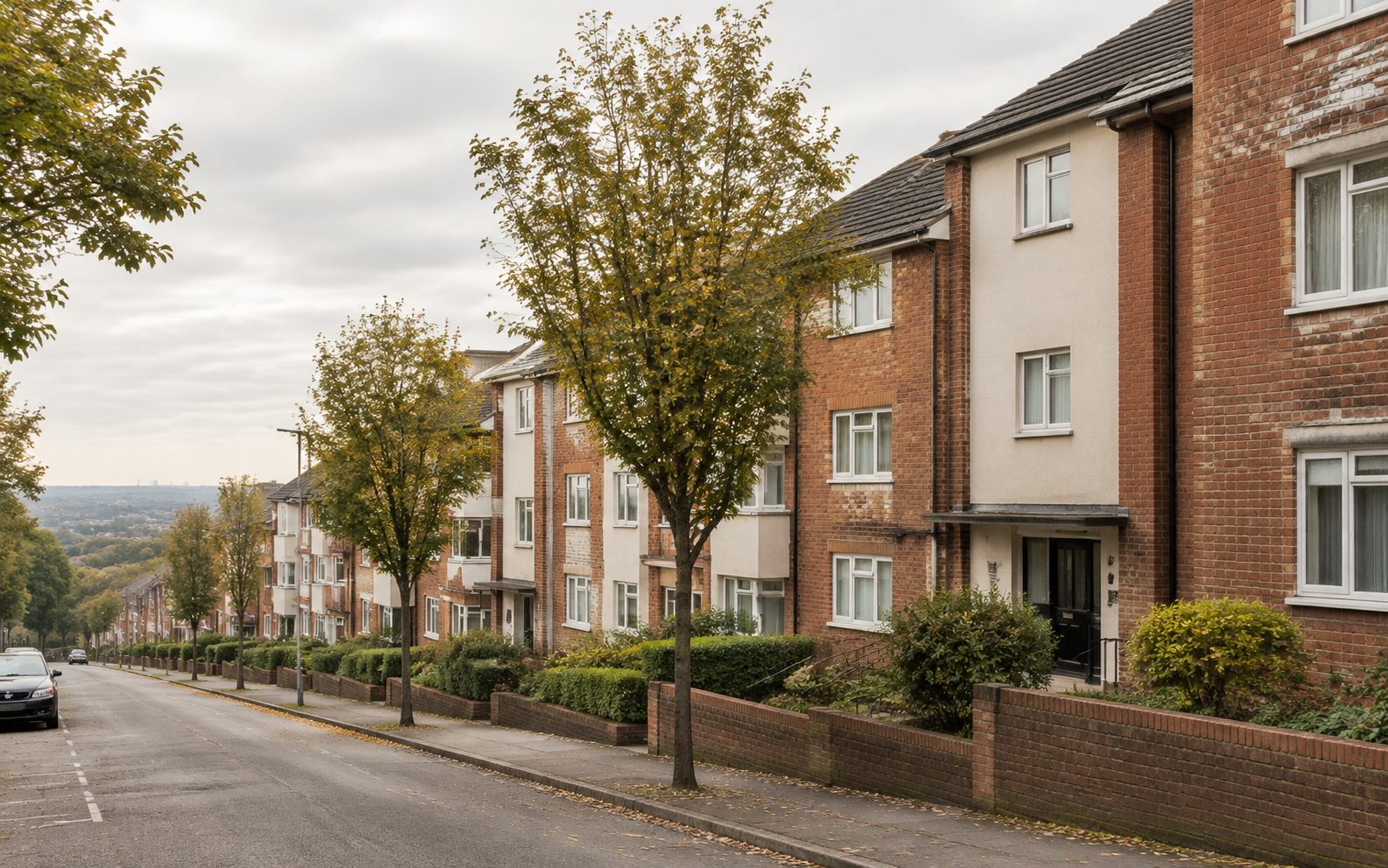 A row of low-rise apartment blocks on a residential street
